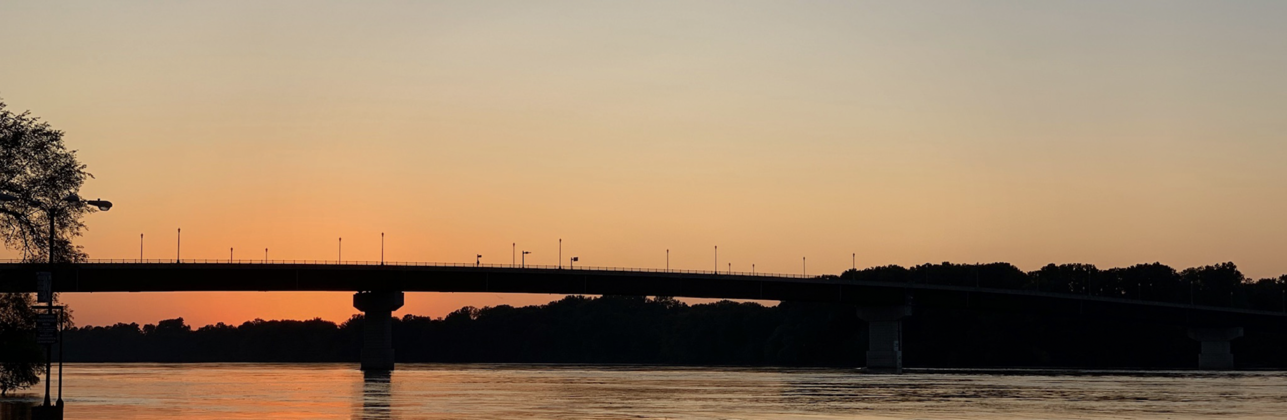 Sunset over the Missouri River and Hermann bridge, viewed from the riverfront in Hermann, MO